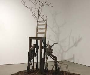 Deception • Full Right View • 2017 • Mixed Media Black Walnut Branch, Found Chair, Acrylic Paint, Sumac Roots and Faux Roots, Black Walnuts, Potting Soil • 112 inches x 70 inches x 60 inches (285 cm x 178 cm x 122 cm)
