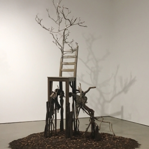 Deception • Full Right View • 2017 • Mixed Media Black Walnut Branch, Found Chair, Acrylic Paint, Sumac Roots and Faux Roots, Black Walnuts, Potting Soil • 112 inches x 70 inches x 60 inches (285 cm x 178 cm x 122 cm)