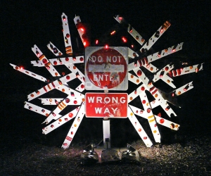 Do Not Enter • Installation and Performance with 40 Minute Sound Loop, Repurposed Street Sign, Painted Wood Shards with Flashing Bicycle lights and Reflectors, 115 x 160 x 48 inches (292.1 x 406.4 x 121.92 cm)
